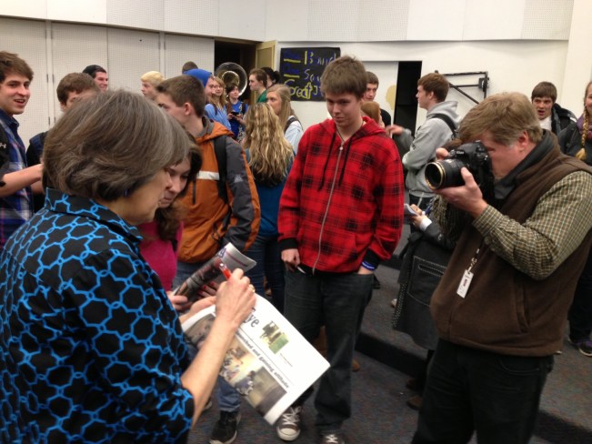 May Beth Tinker autographing copies of the Ferndale High School student newspaper, The Eagle Eye, for its student editors.
