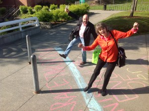 Mary Beth Tinker and Mike Hiestand cross the "official" Tinker Tour finish line at Mountlake Terrace High School May 1